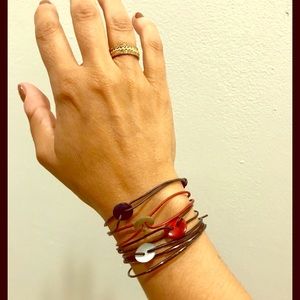 Bundle of five mixed material bracelets.